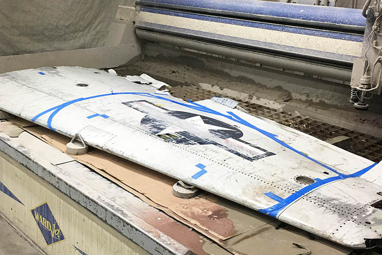Koss cuts a jet wing with a waterjet cutter
